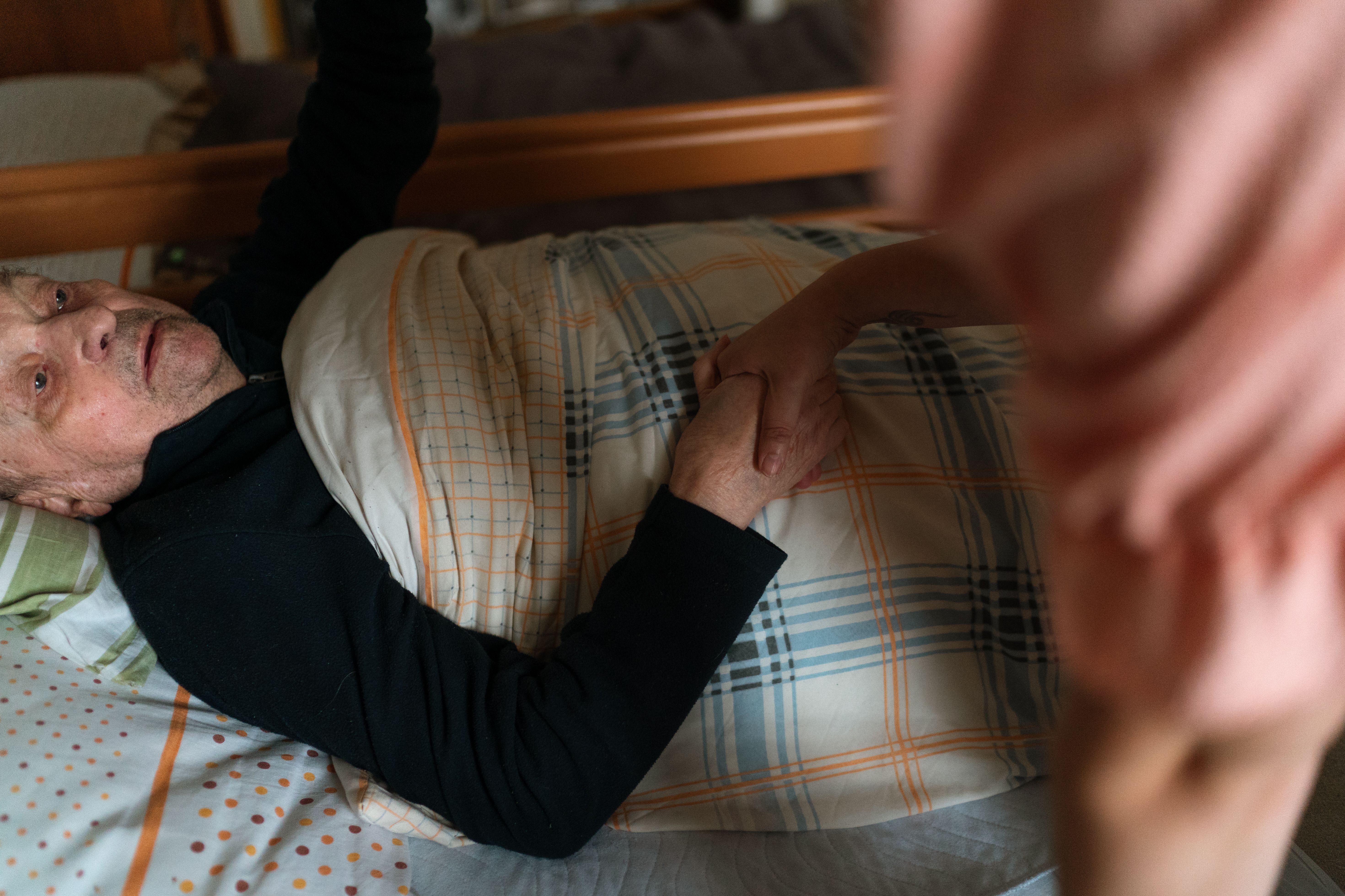 A caregiver offering thoughtful support to an older adult