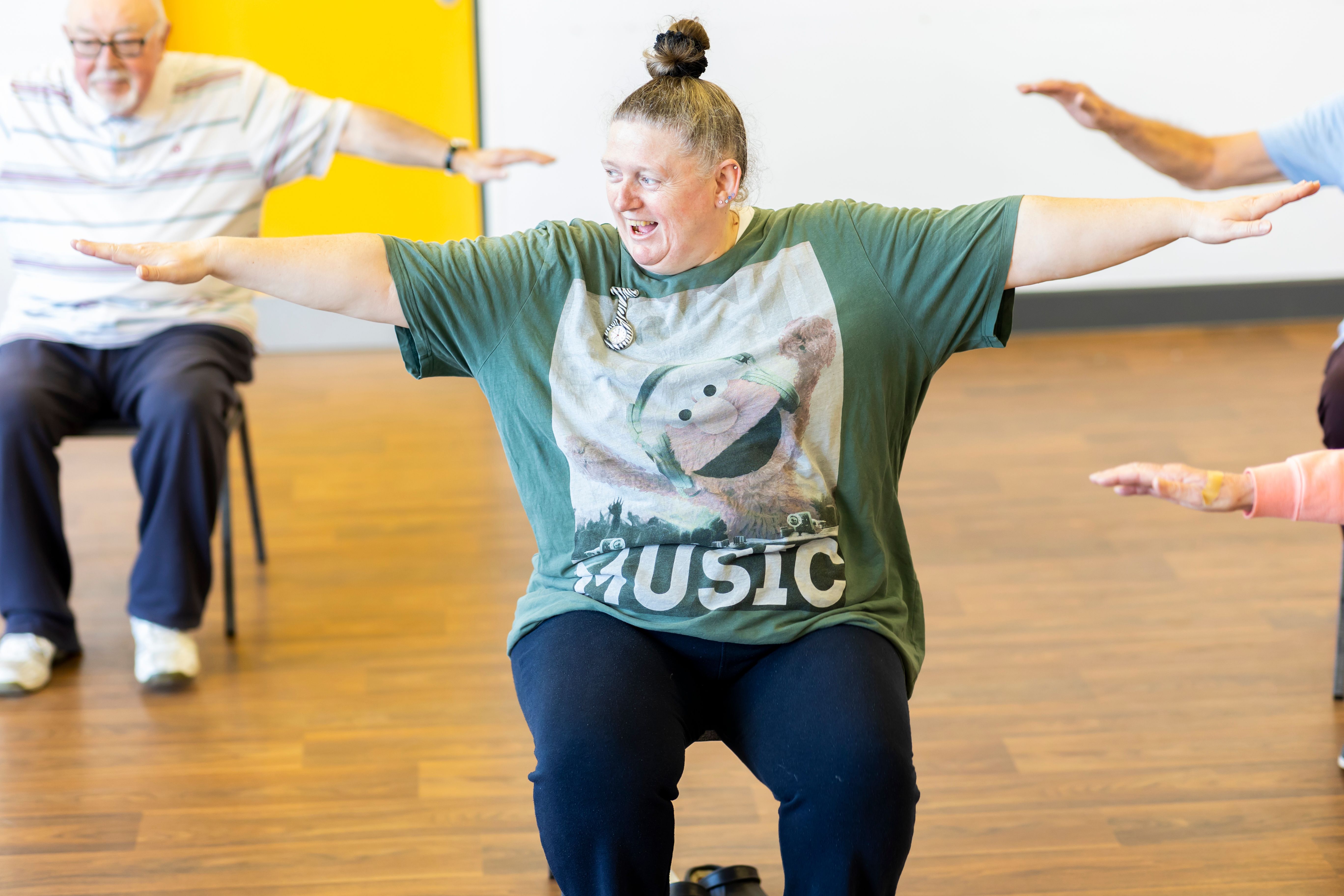 Older adults taking part in a seated group activity